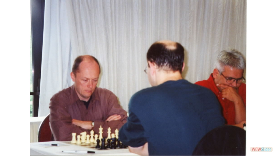 FM Igor Nikolayev vs GM Joel Benjamin at NY State Championship, Kerhonkson, NY, 2002. GM Ildar Ibragimov on the right.