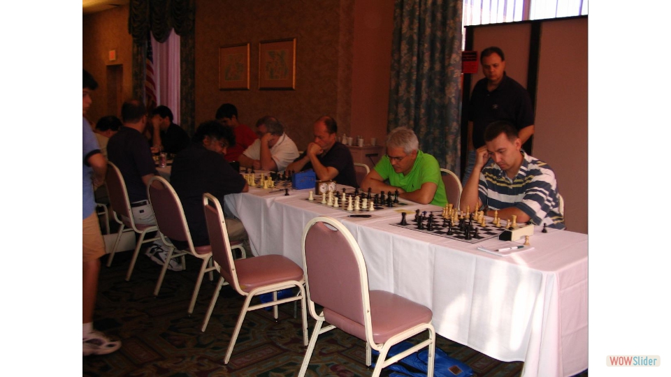 127th New York State Championship, Monticello NY, 2004. FM Igor Nikolayev (with black) vs FM Weeramantry. GMs Ildar Ibragimov and Gata Kamsky on the right. Winning the game Igor tied for 2nd with GM Ibragimov, after Gata.